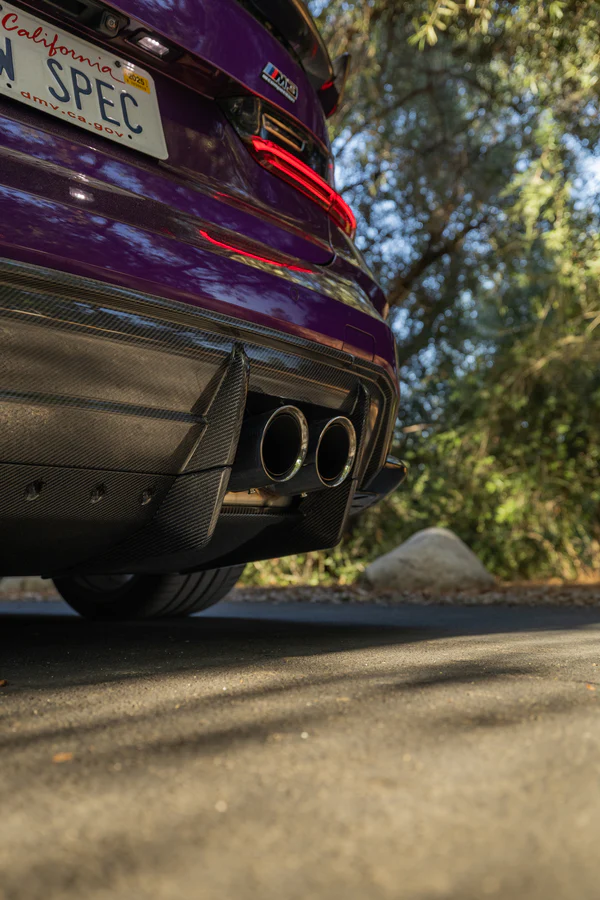 Purple sports car with dual exhaust, close-up of rear bumper and license plate