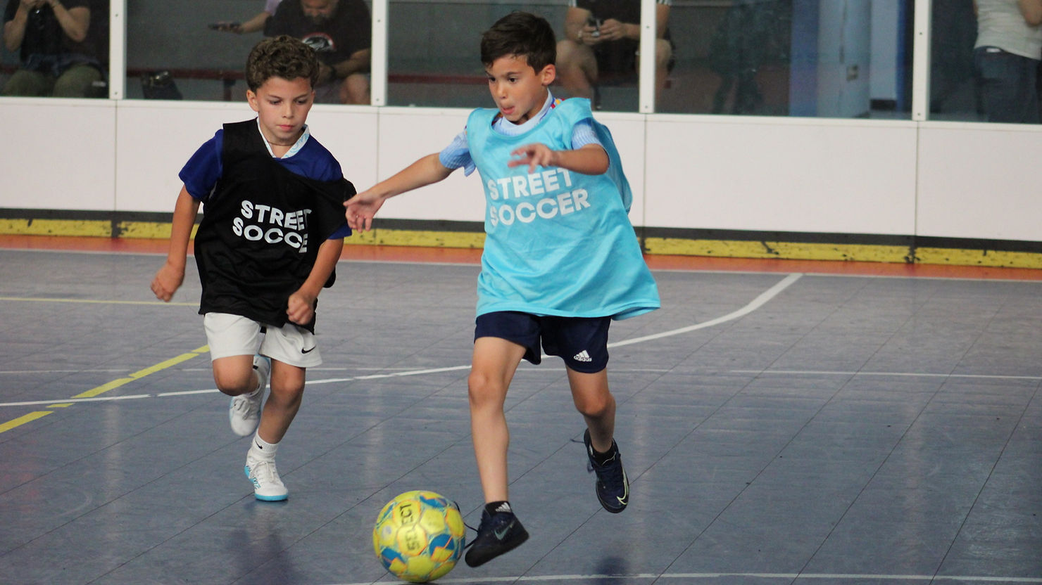 Youth playing street soccer