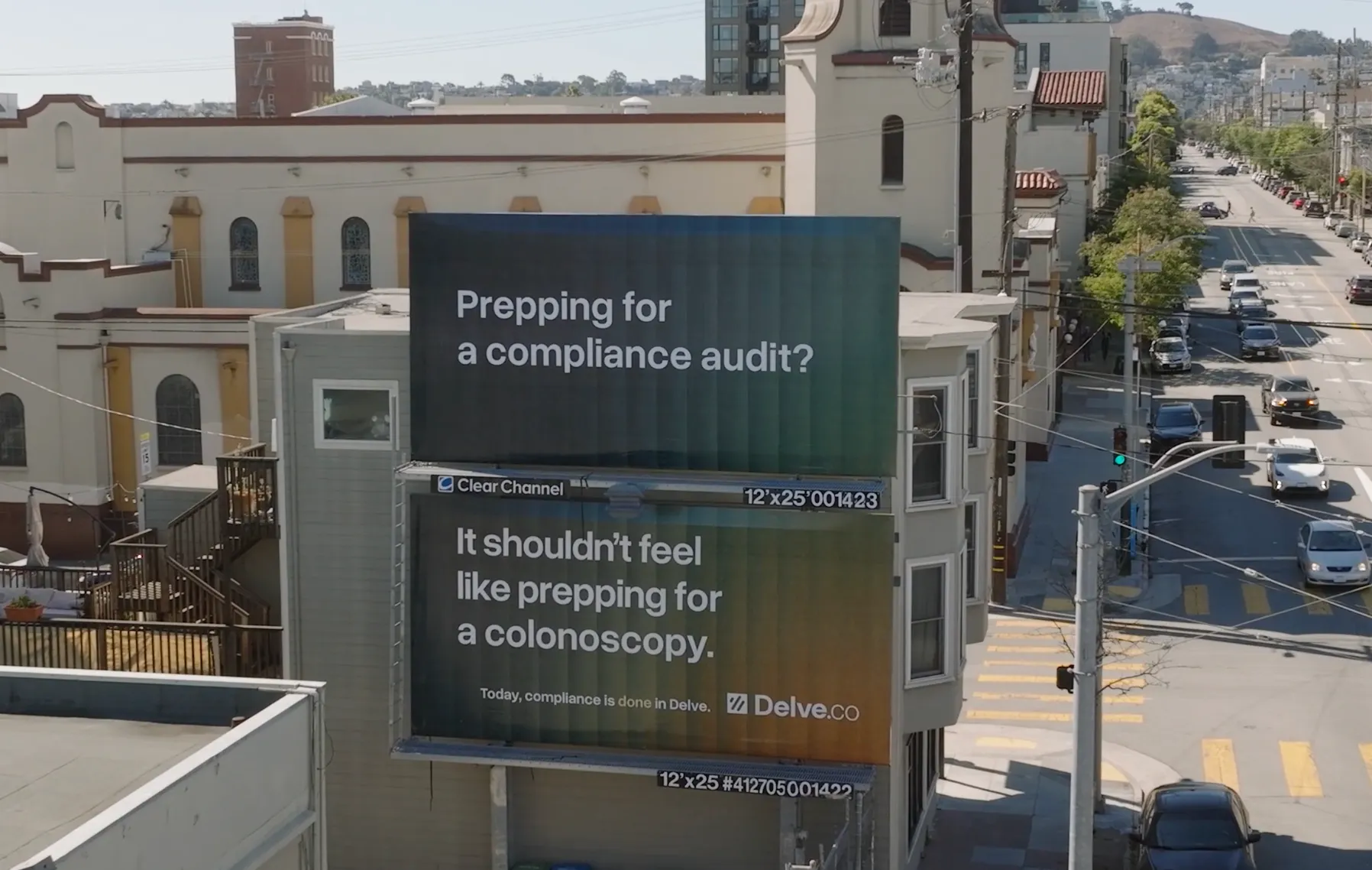 Two stacked billboards on a building with text about compliance audits and colonoscopy prep, advertising Delve.co.