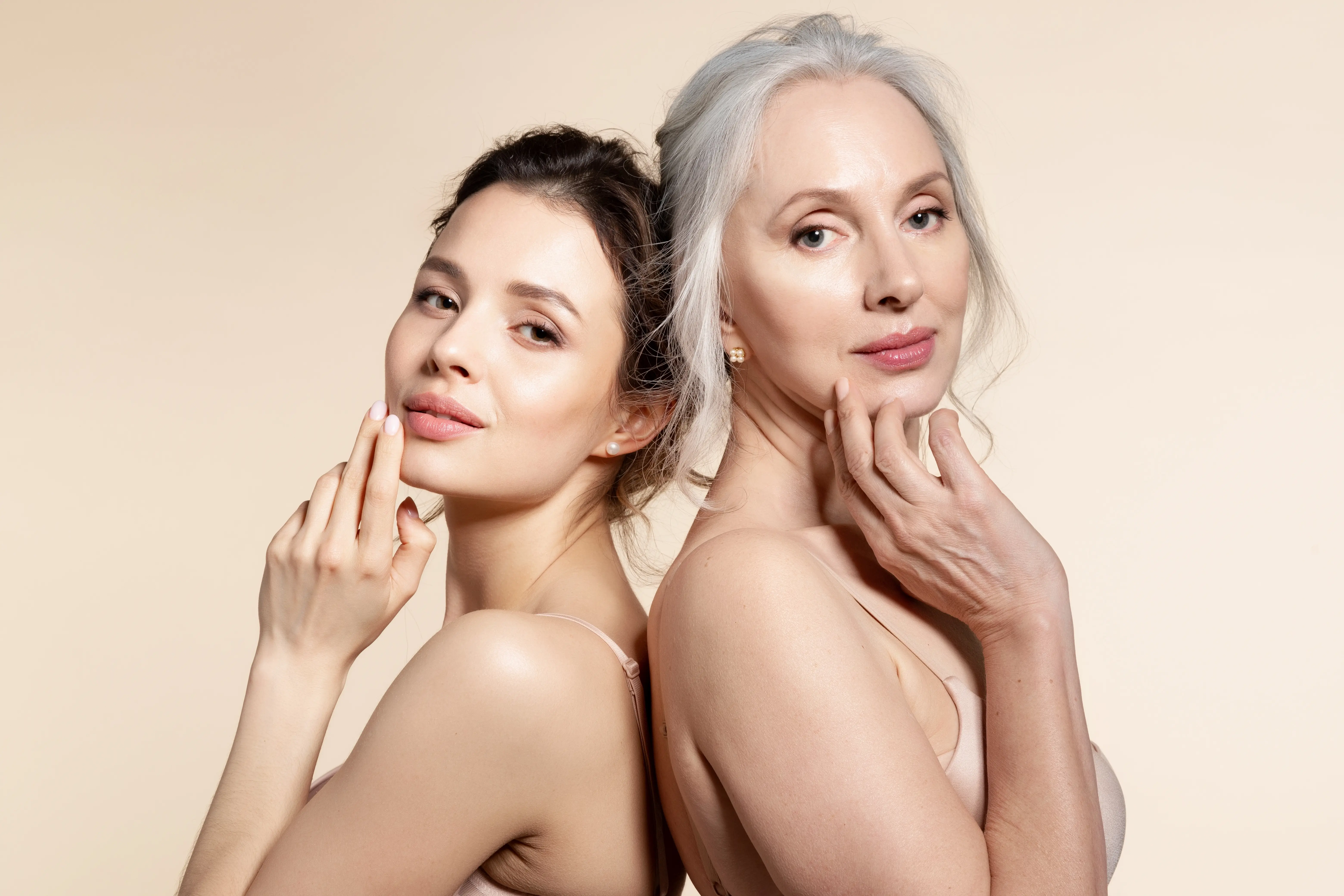Two women with white hair are posing for a picture.