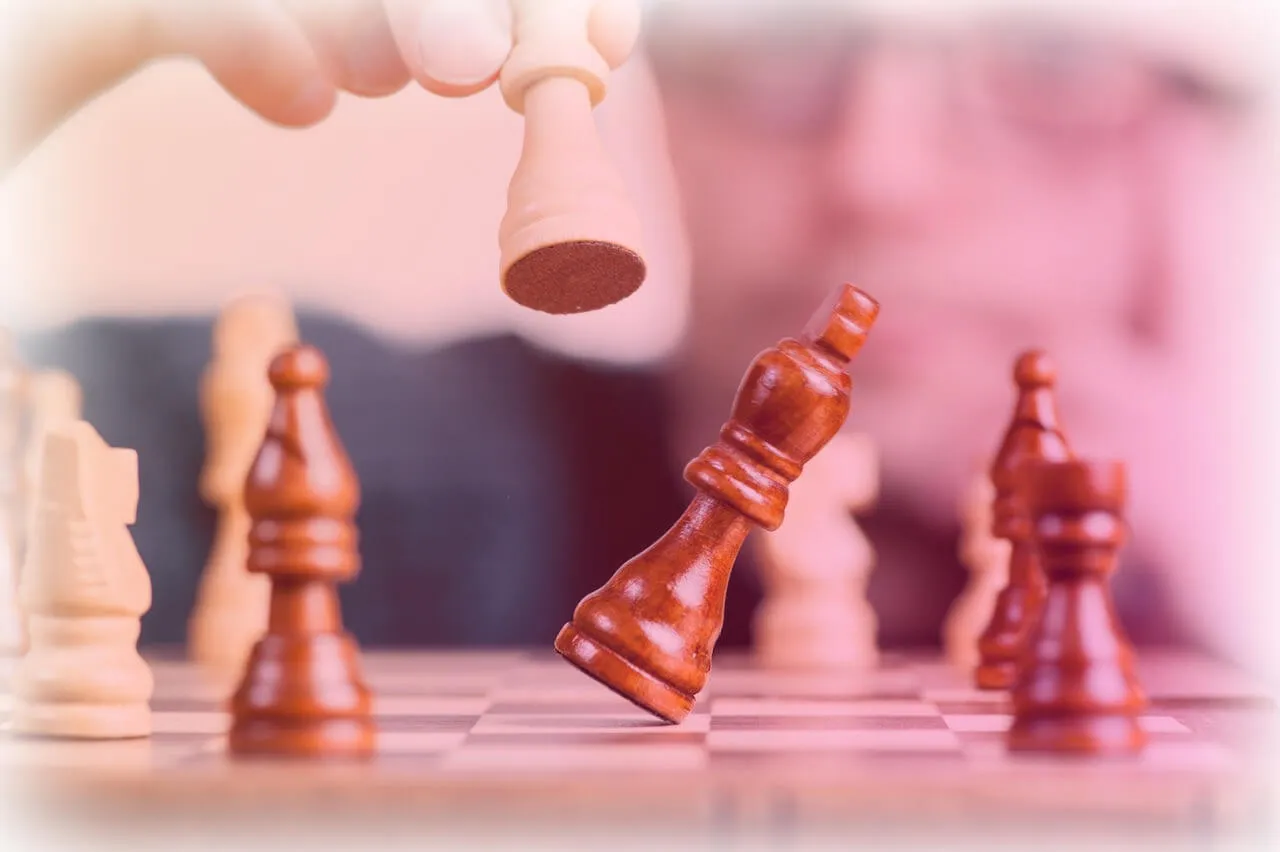 A chess game where the player is currently knocking over one of the pieces. 