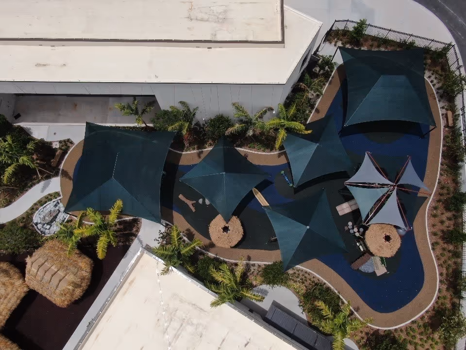 Aerial view of a completed courtyard with shade sails in Broward county.