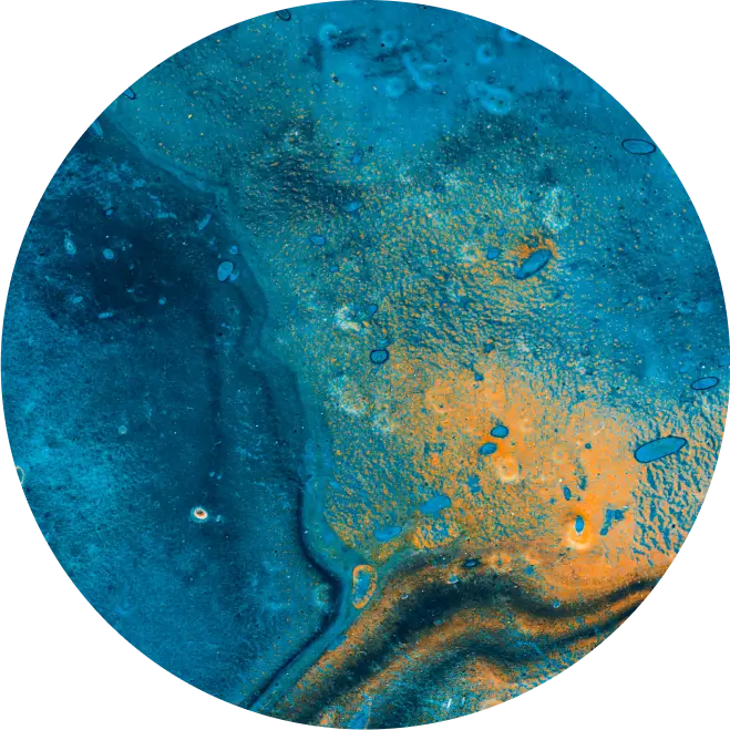 Circular abstract image with textured blue and orange patterns resembling a mineral or geological surface.