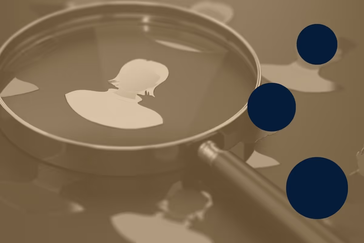 A magnifying glass on top of an icon of a person