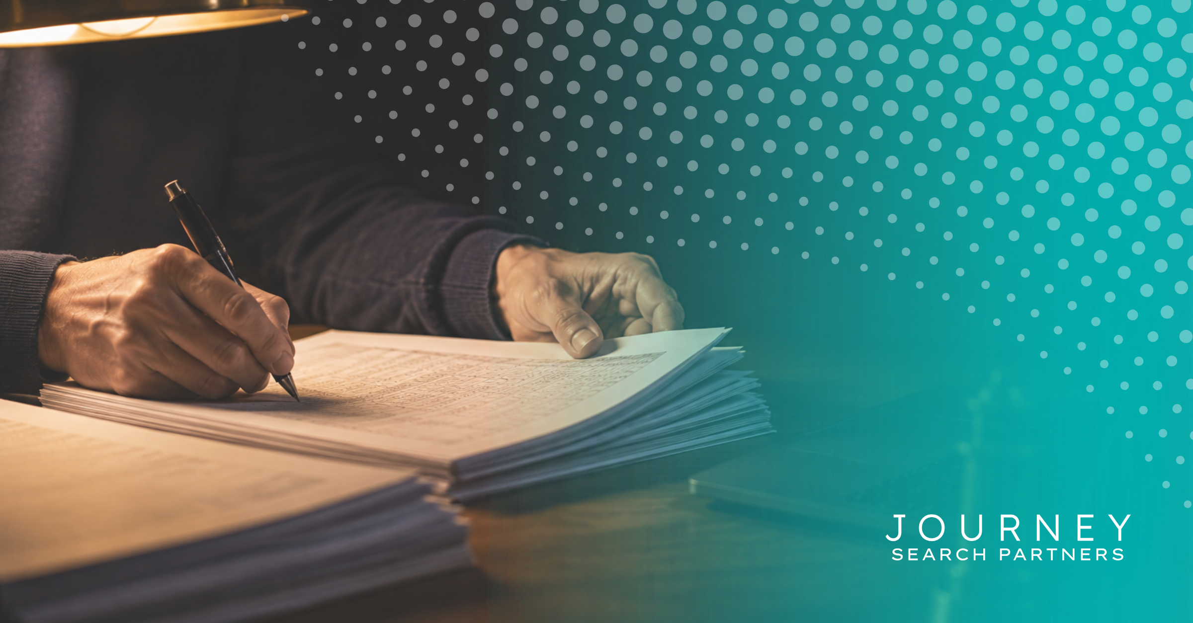A person's hands writing on a stack of financial reports at a desk, representing the reporting and oversight a controller brings to a finance function.