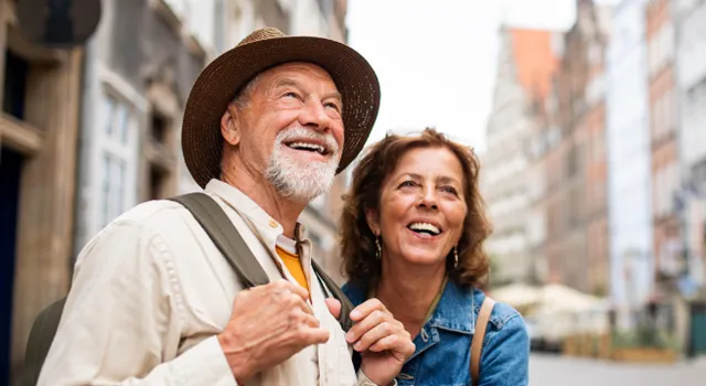 Couple travelling with backpacks and smiling