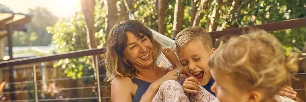 Woman in hammock with her children