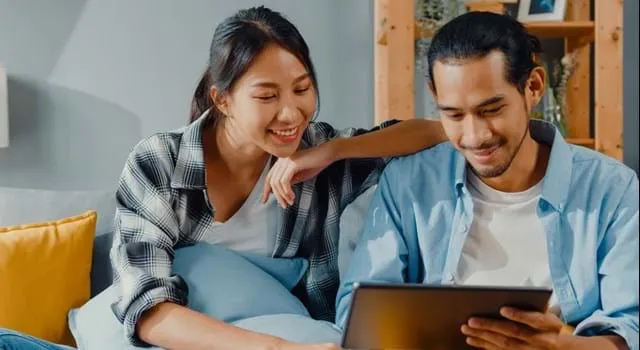 Couple reading ipad