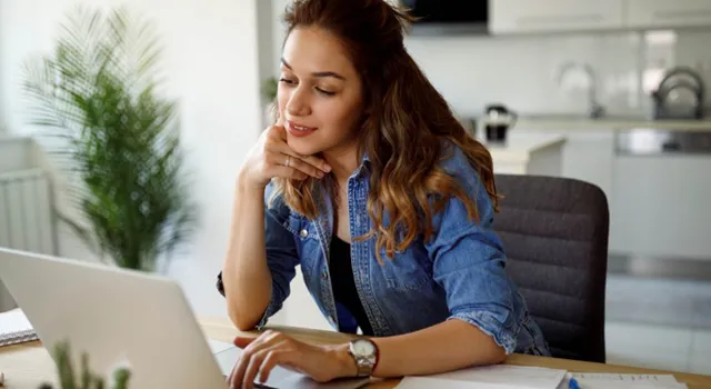 Young woman reading her laptop screen