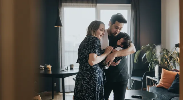 Couple holding a newborn baby