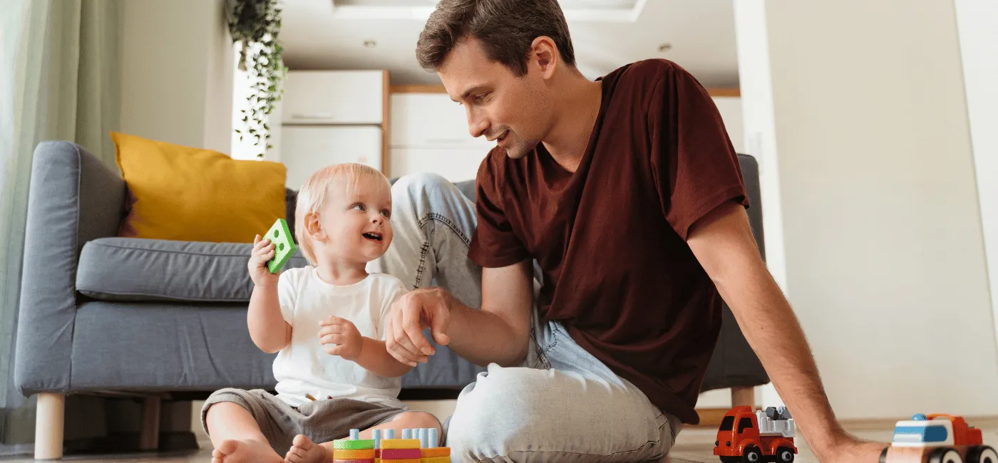 Father and son playing with toys on the floor