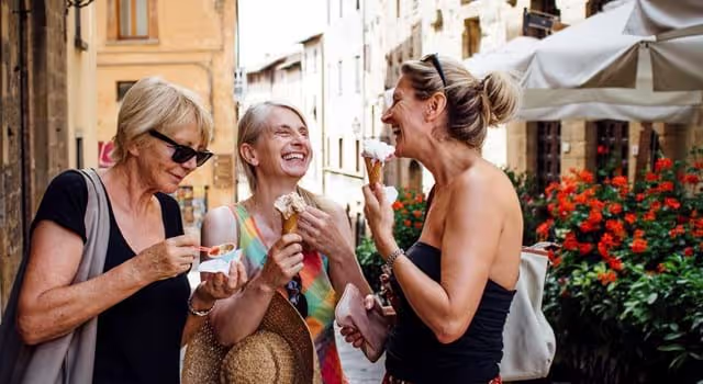 Friends on holiday in Europe eating ice-cream