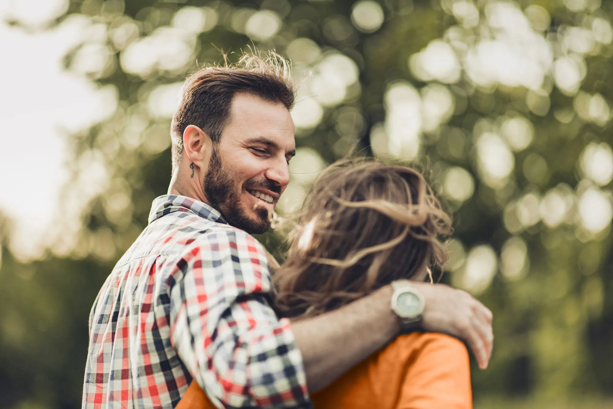 Couple embracing arms around each other