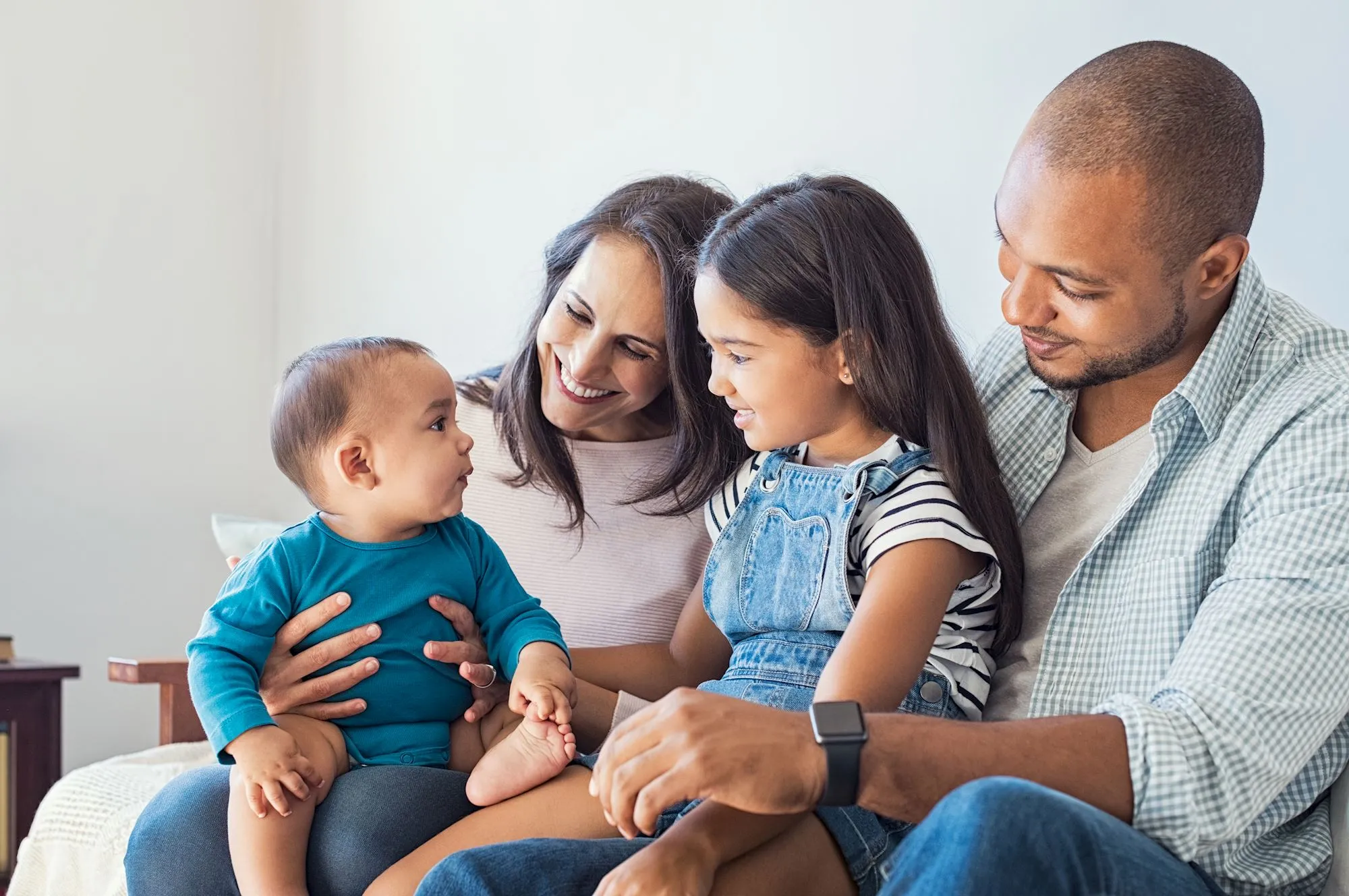 Young family sitting on their couch