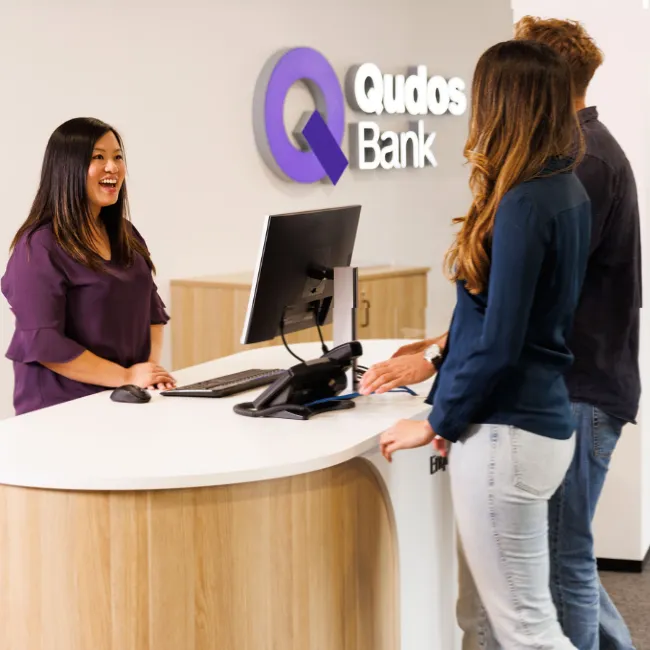 Qudos Bank staff speaking with customers in branch