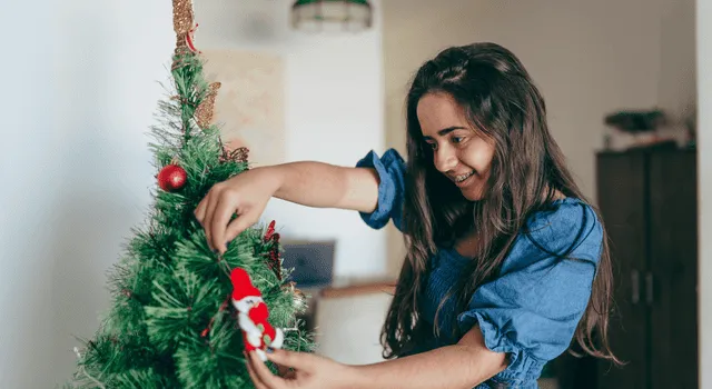Woman decorating her christmas tree