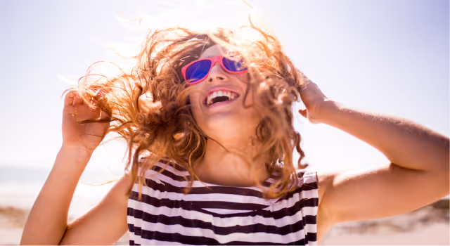 Woman smiling with sunglasses on
