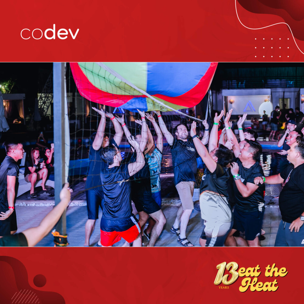 CoDev celebrates 13th anniversary by playing beach volleyball.