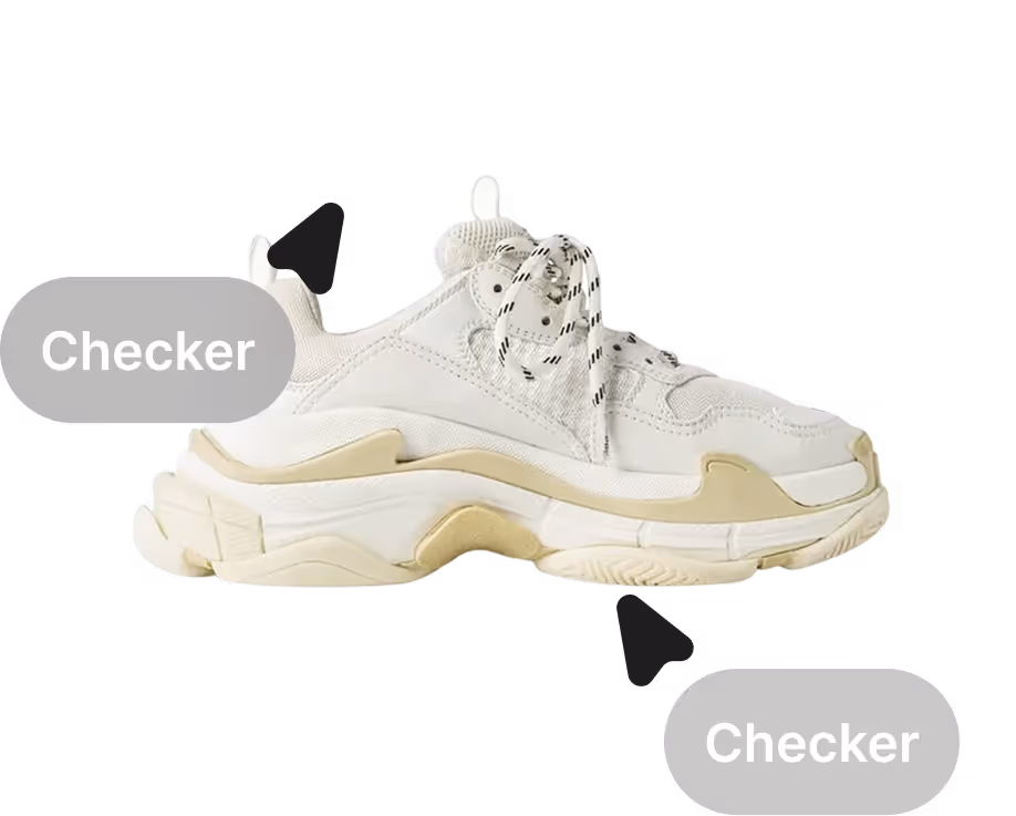 Two authenticators checking a sneaker
