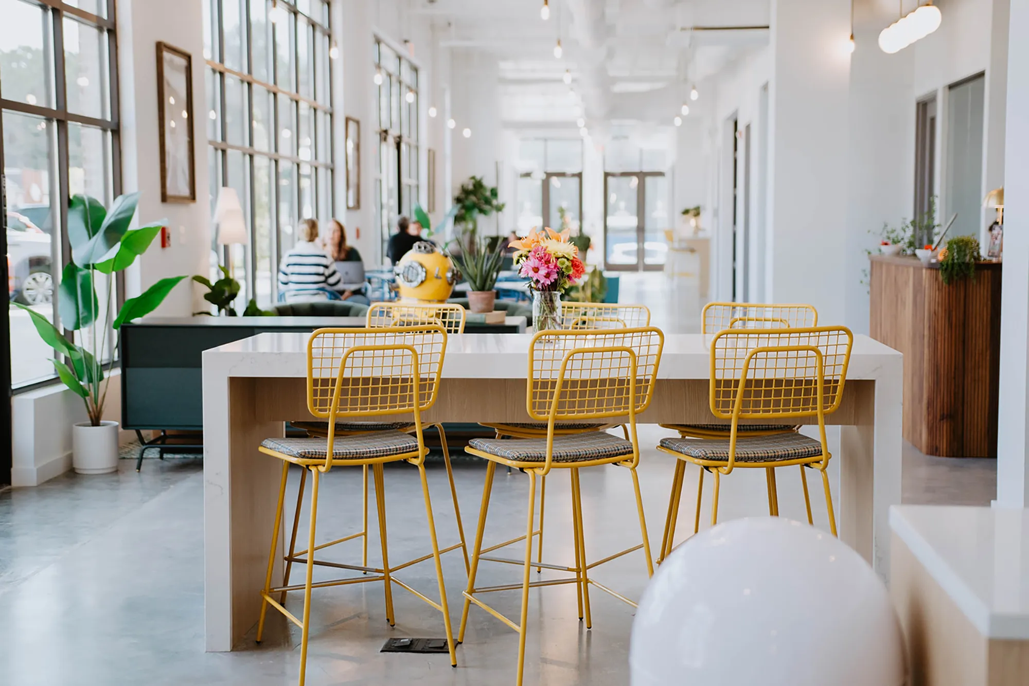 a room with yellow chairs and a table