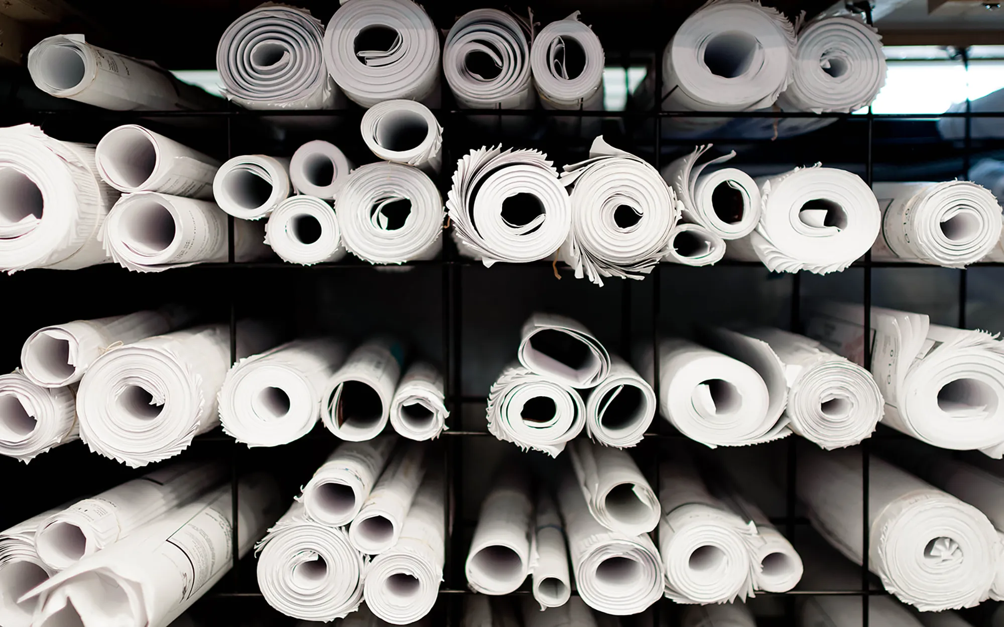 a shelf with rolls of paper