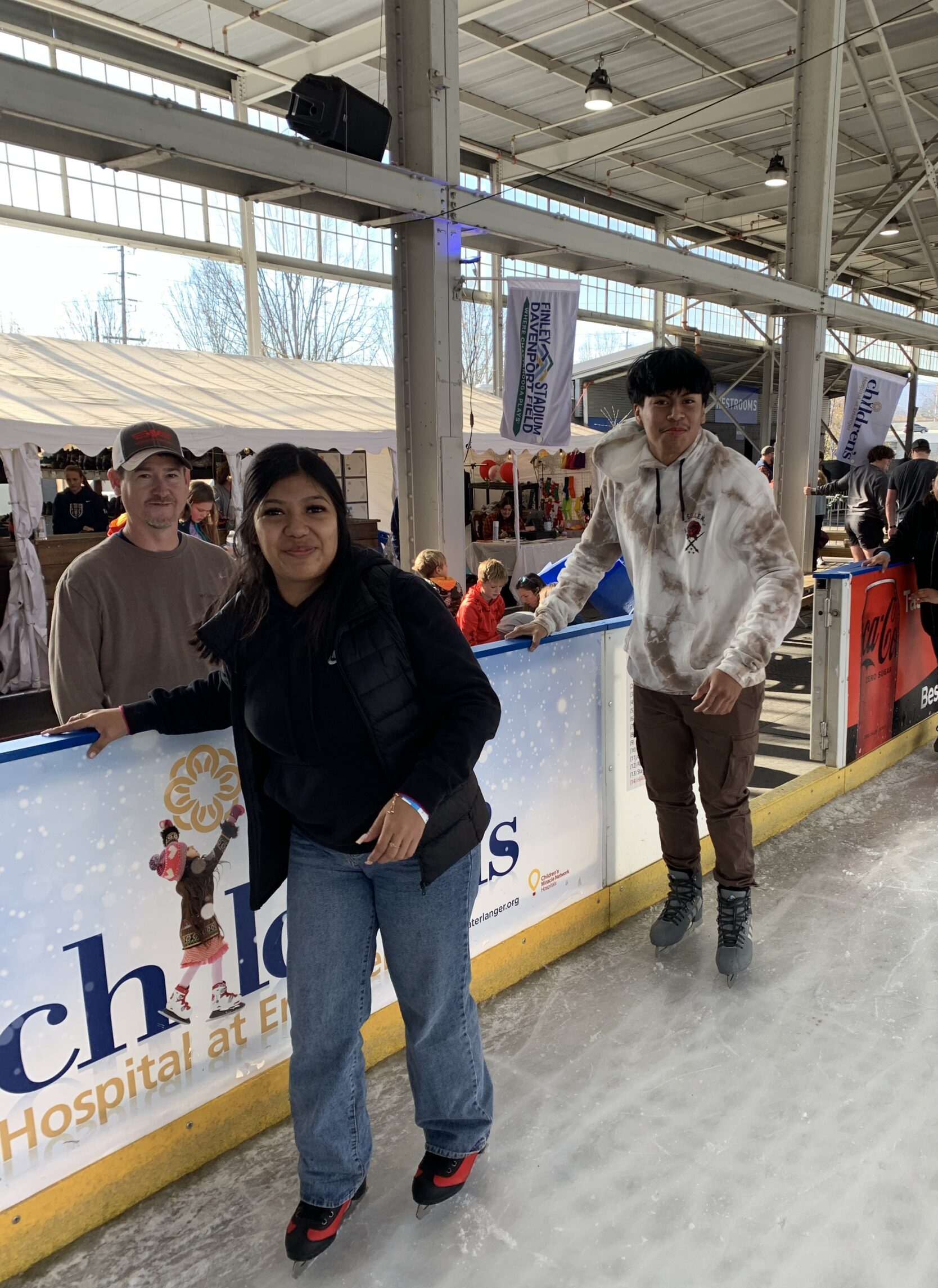 Young Latina girl smiling while ice skating.