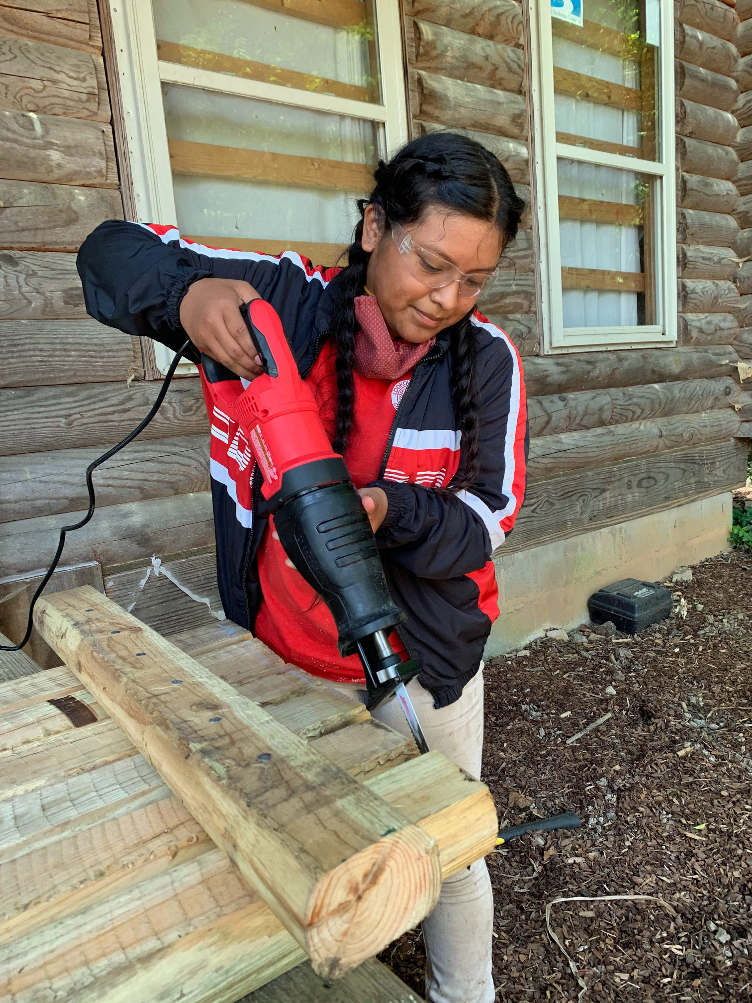 Intern Jennifer using a reciprocating saw