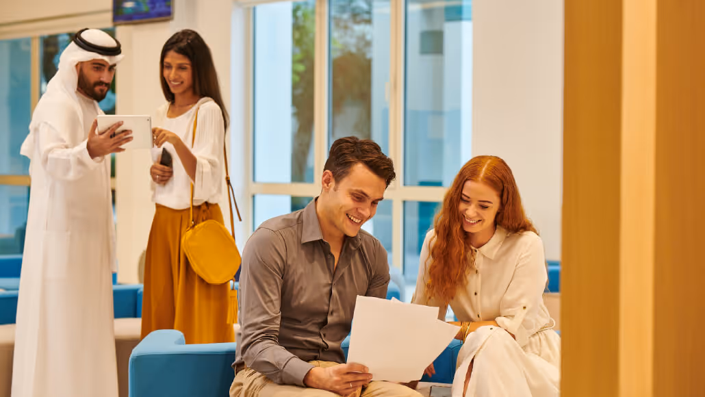 Young professionals collaborating in Dubai Knowledge Park office lobby.