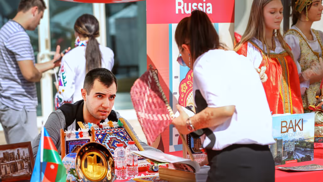 Visitor exploring traditional crafts during Dubai Knowledge Park cultural fair.