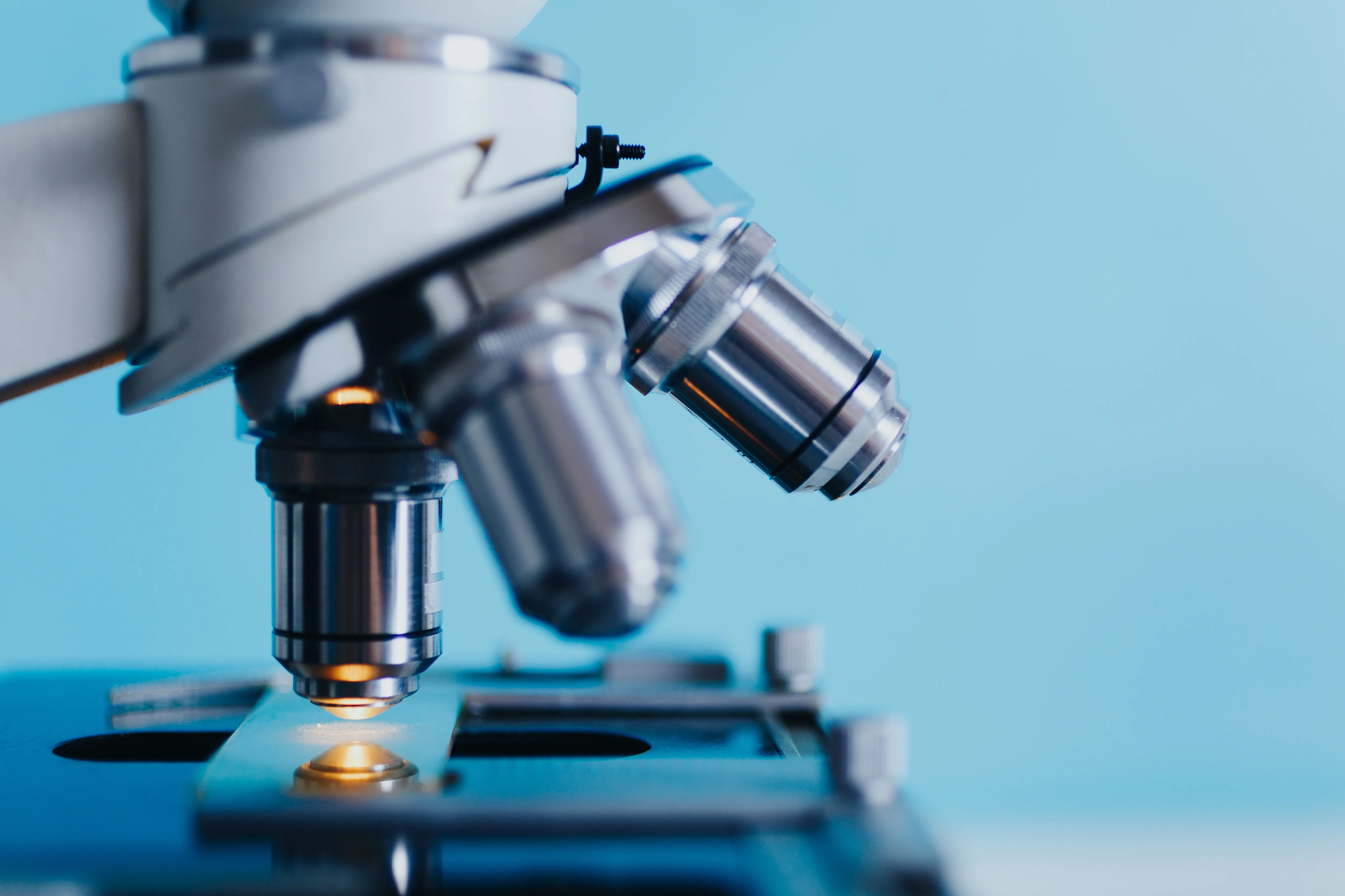 close up of a microscope on a blue background