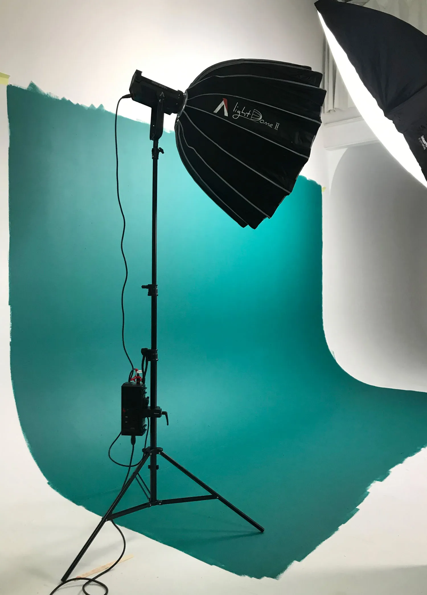 A cyclorama background painted teal for Goodlawyers brand colours