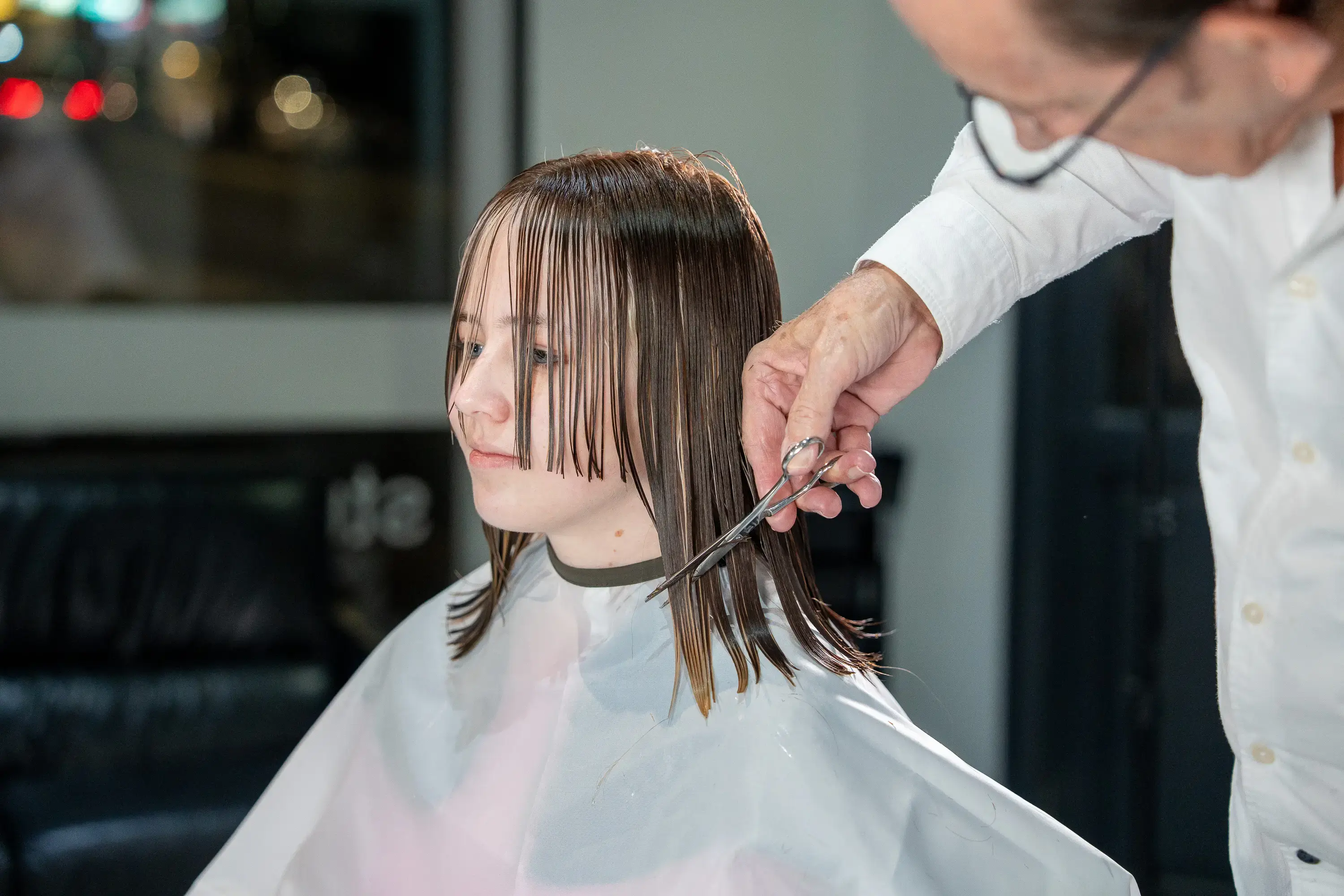 Stylist performing a precision haircut at Studio on Willoughby