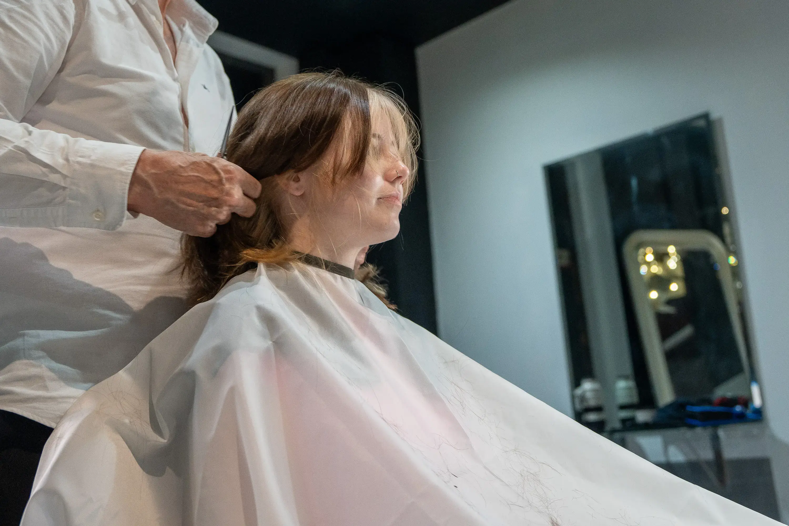 Scissors trimming blonde ends during a restyle appointment
