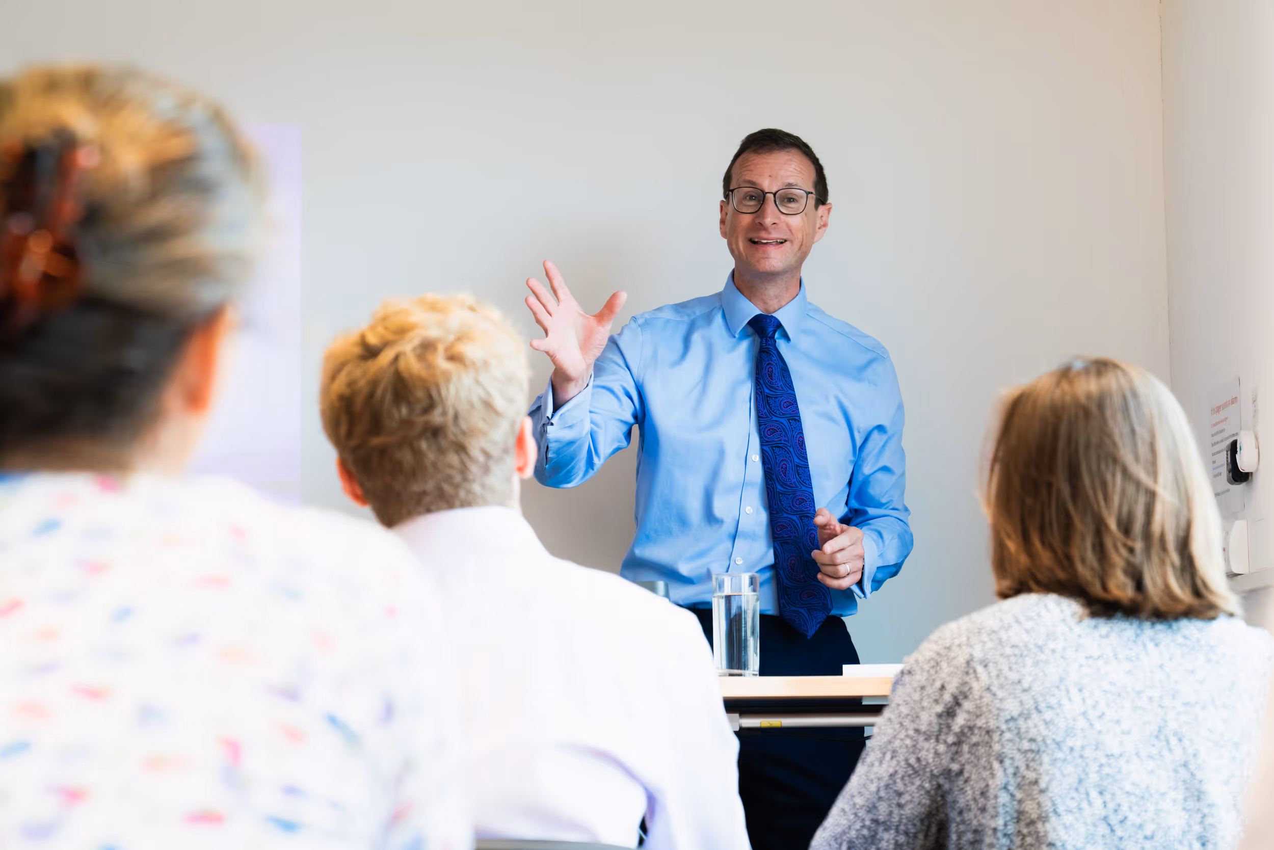 David Culley standing in a classroom full of students teaching. 