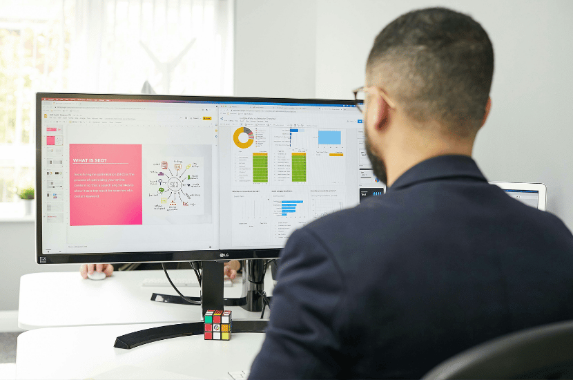 A software engineer analyzing code on a computer monitor, representing system maintenance, debugging, and software optimization.