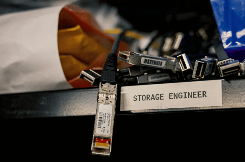 Tangled outdated cables piled on storage shelves, visually representing legacy system complexities and infrastructure challenges requiring modernization.