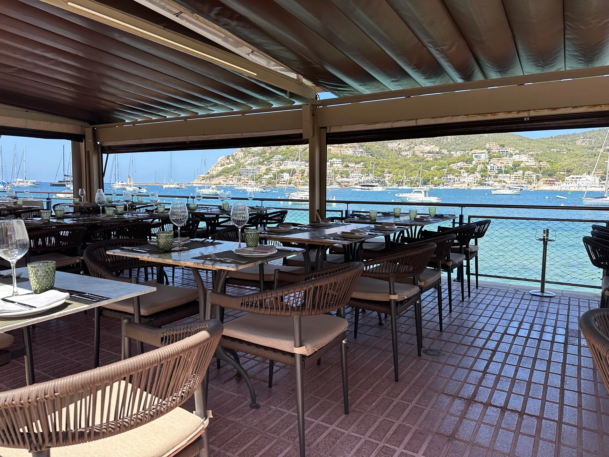 Seaside restaurant with stunning marina view and empty dining tables