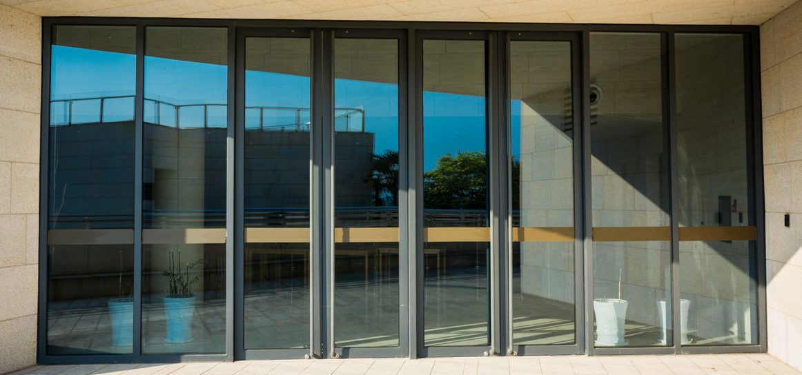 Aluminium bifold doors with panels showing signs of sticking and alignment issues.
