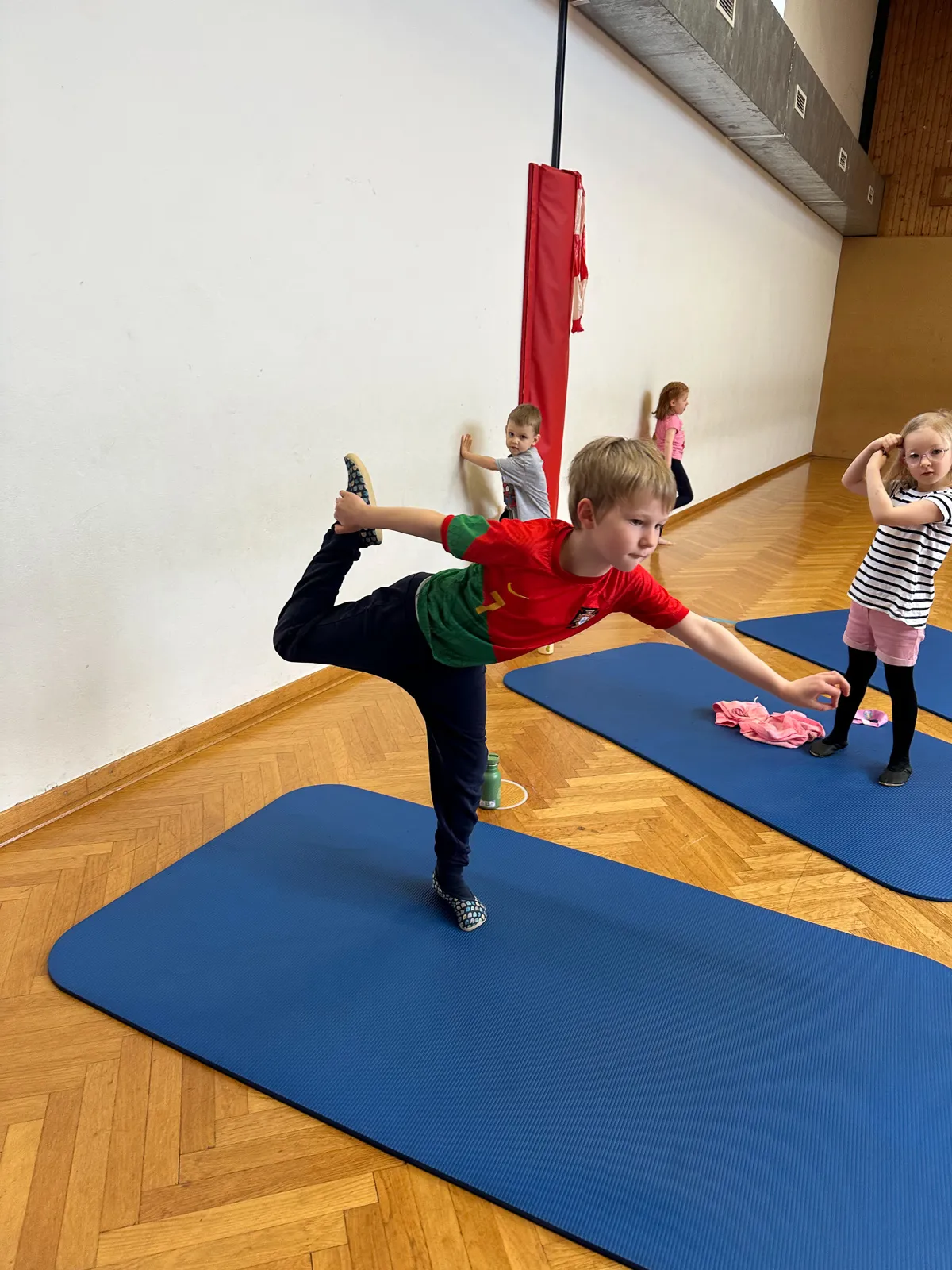 Kinderyoga Melk – Junge trainiert Balance im Yoga-Kurs.