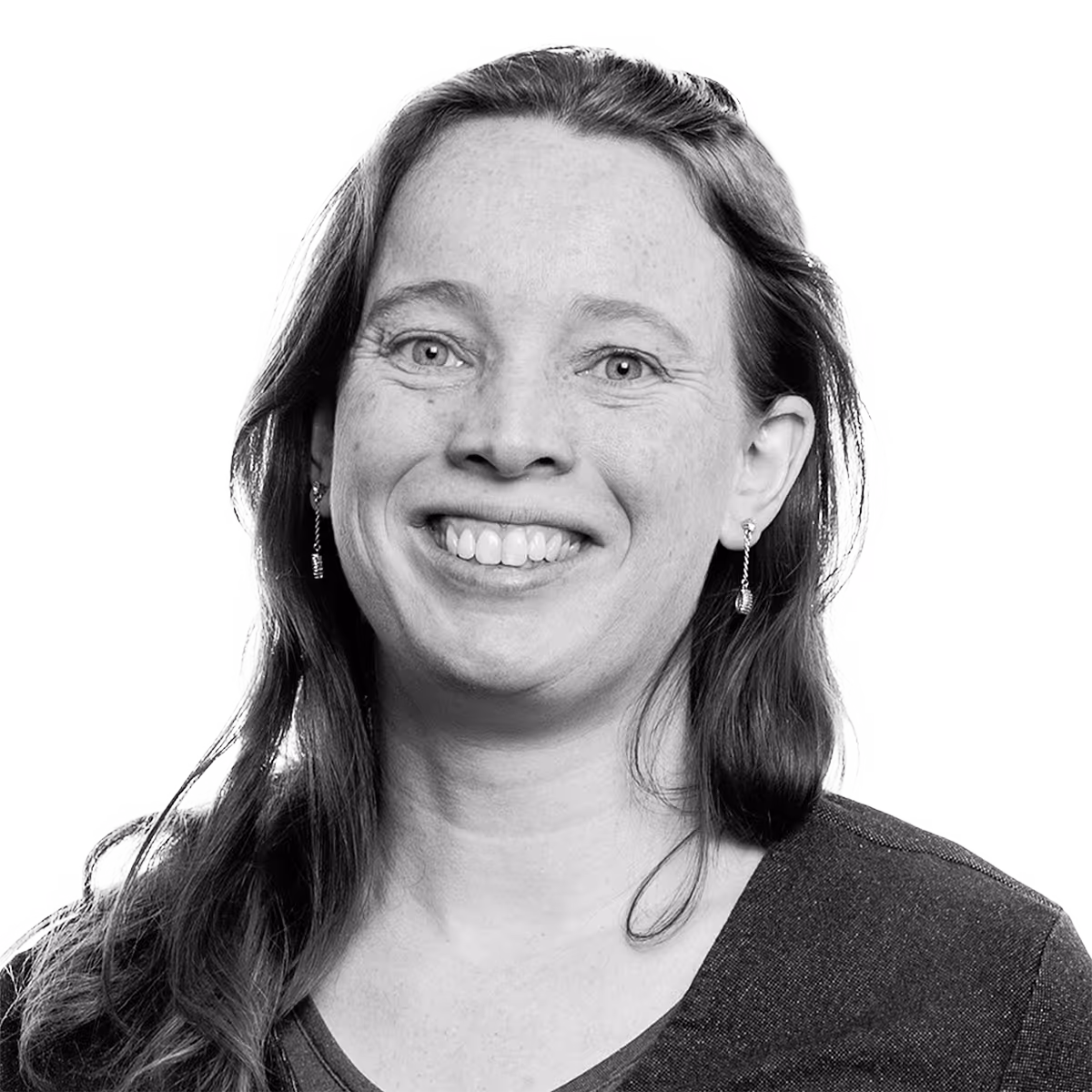 Black and white portrait of a smiling woman with long hair