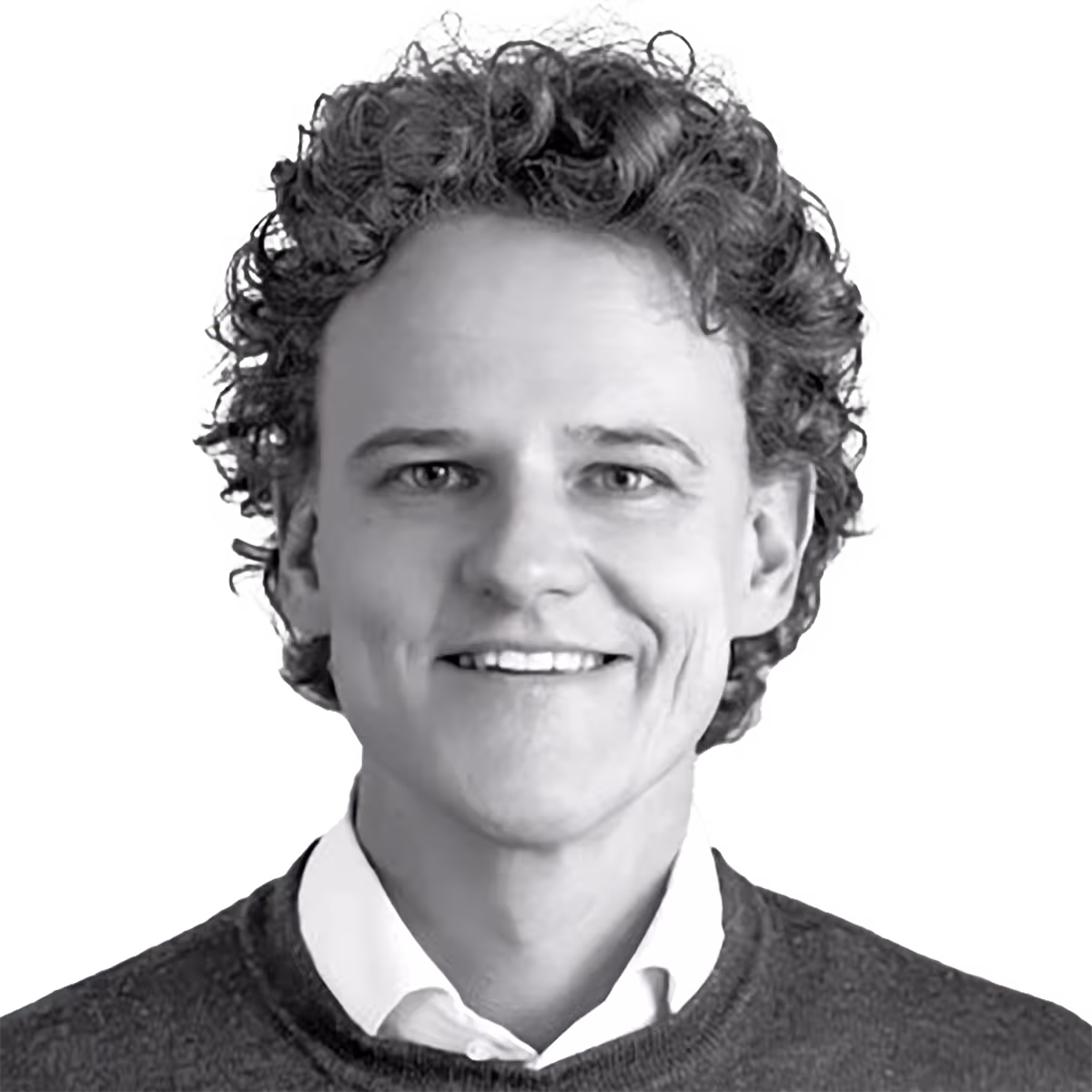 Smiling person with curly hair wearing sweater and collared shirt