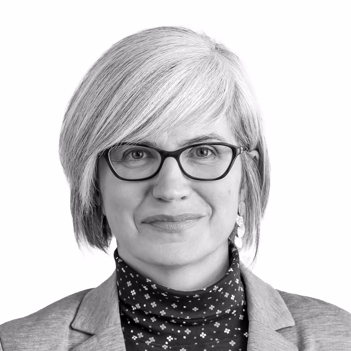 Professional portrait of a person with glasses and short hair