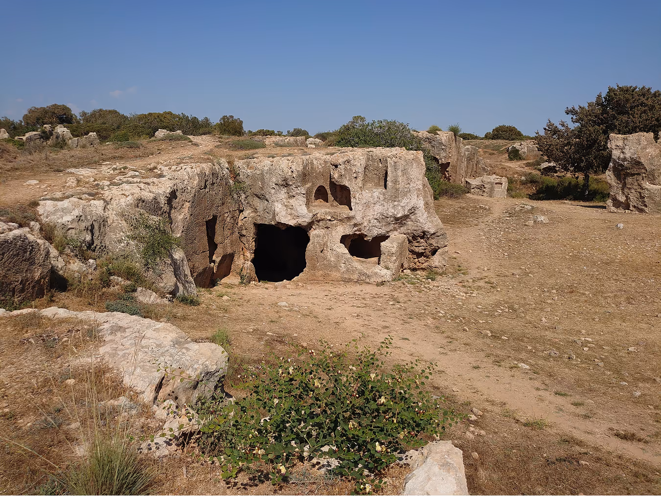 A picture of a historical place, Aphrodite`s rock, the image shows a beach filled with rocks