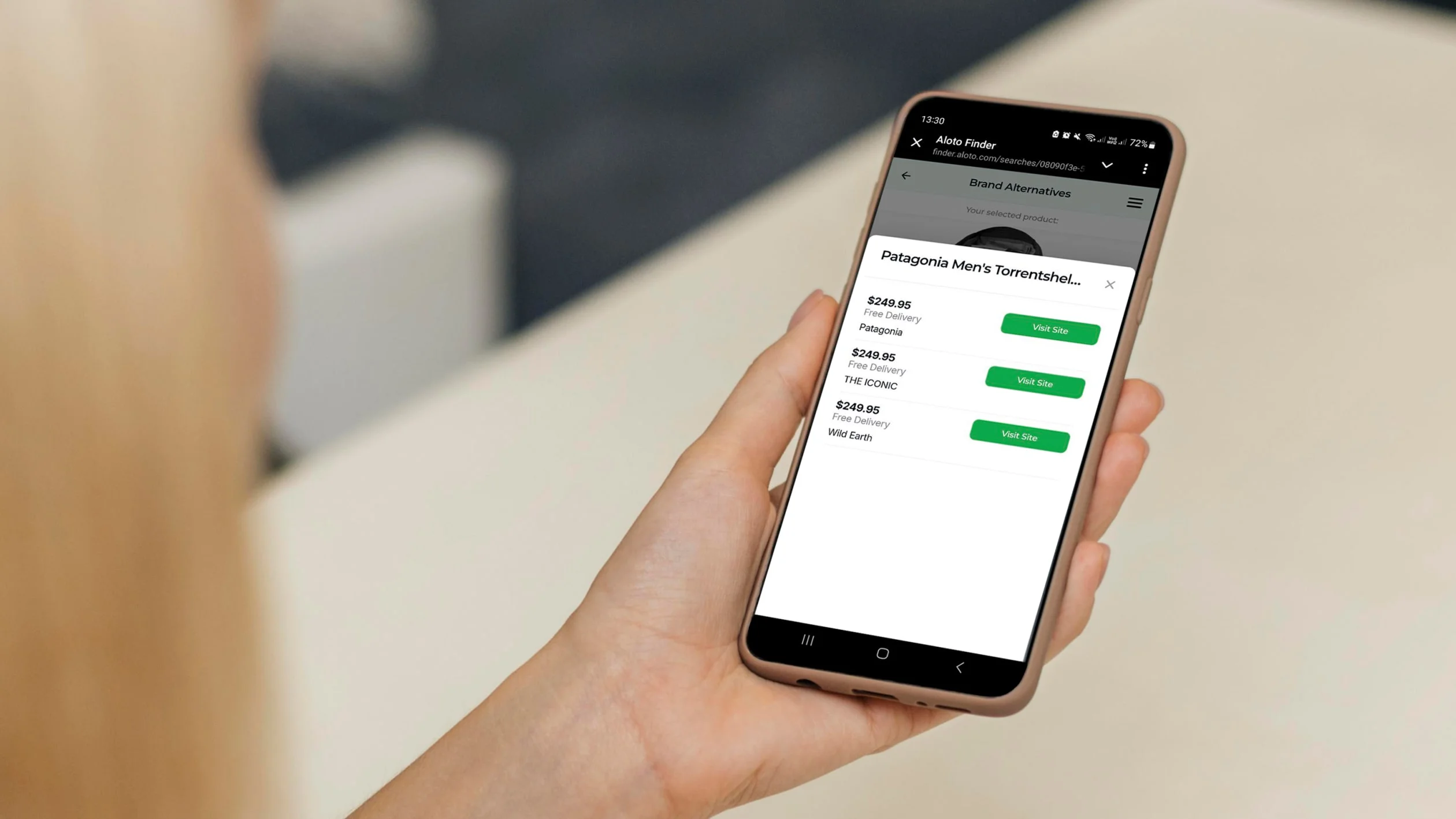 A woman holds a smartphone displaying an app on the screen, focused on its features and functionality.