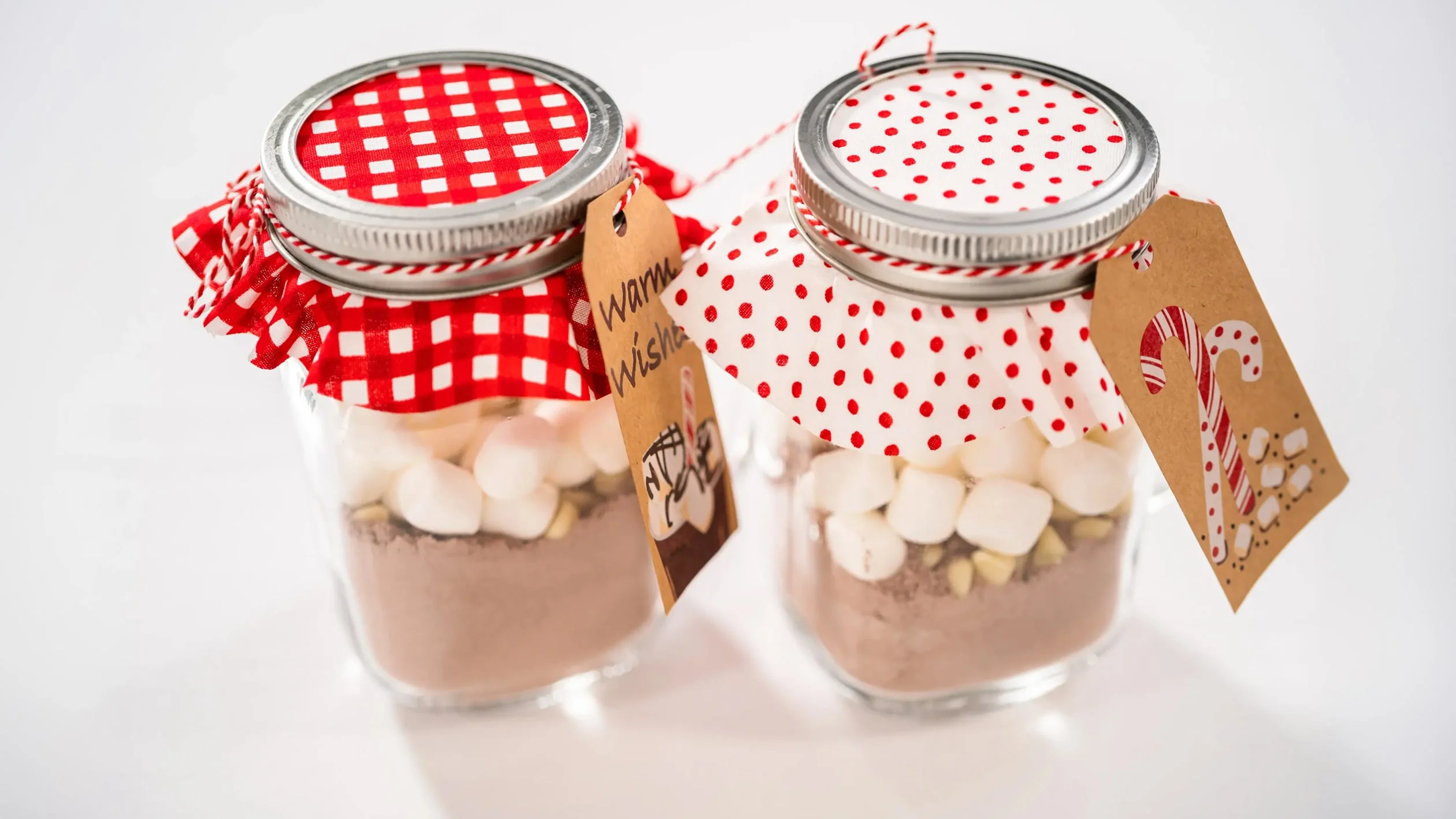 Two jars filled with chocolate and marshmallows, showcasing a sweet treat combination for desserts or snacks.