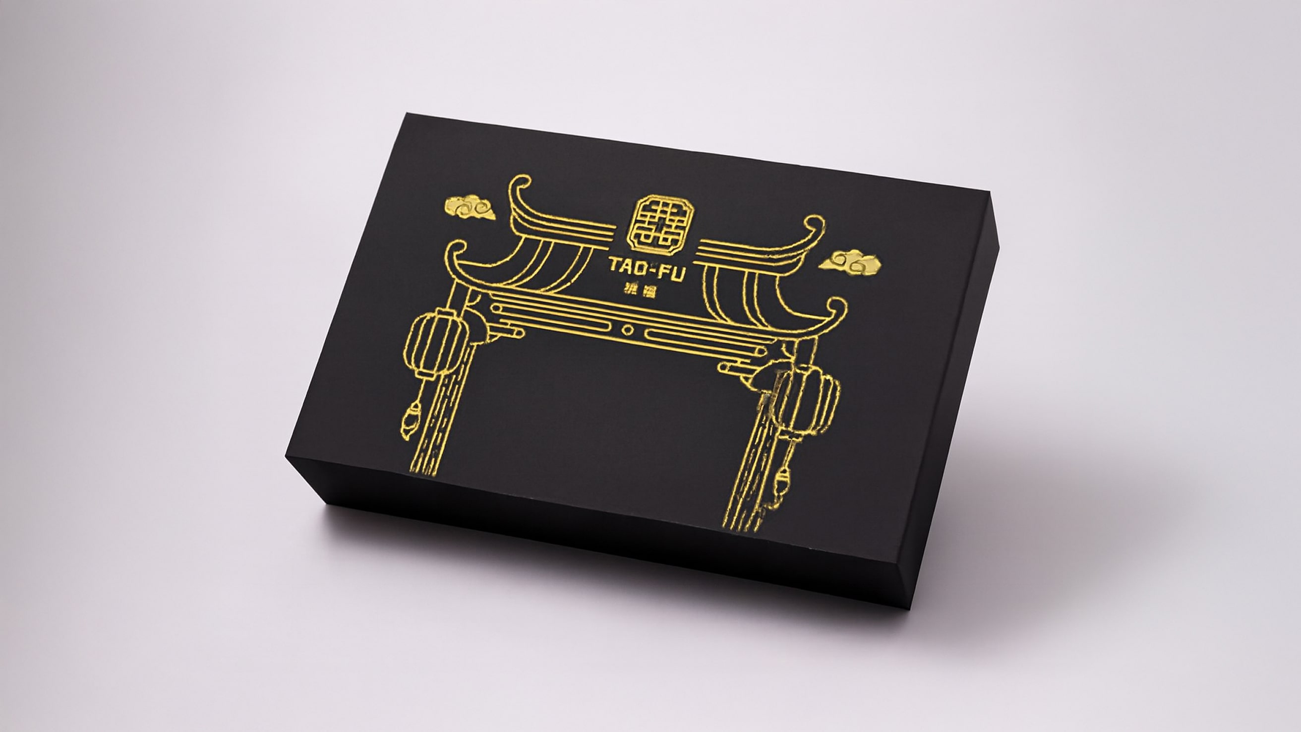 Black rectangular box with gold line art of a traditional Chinese archway and lanterns, featuring the text 'TAO-FU' in the center.