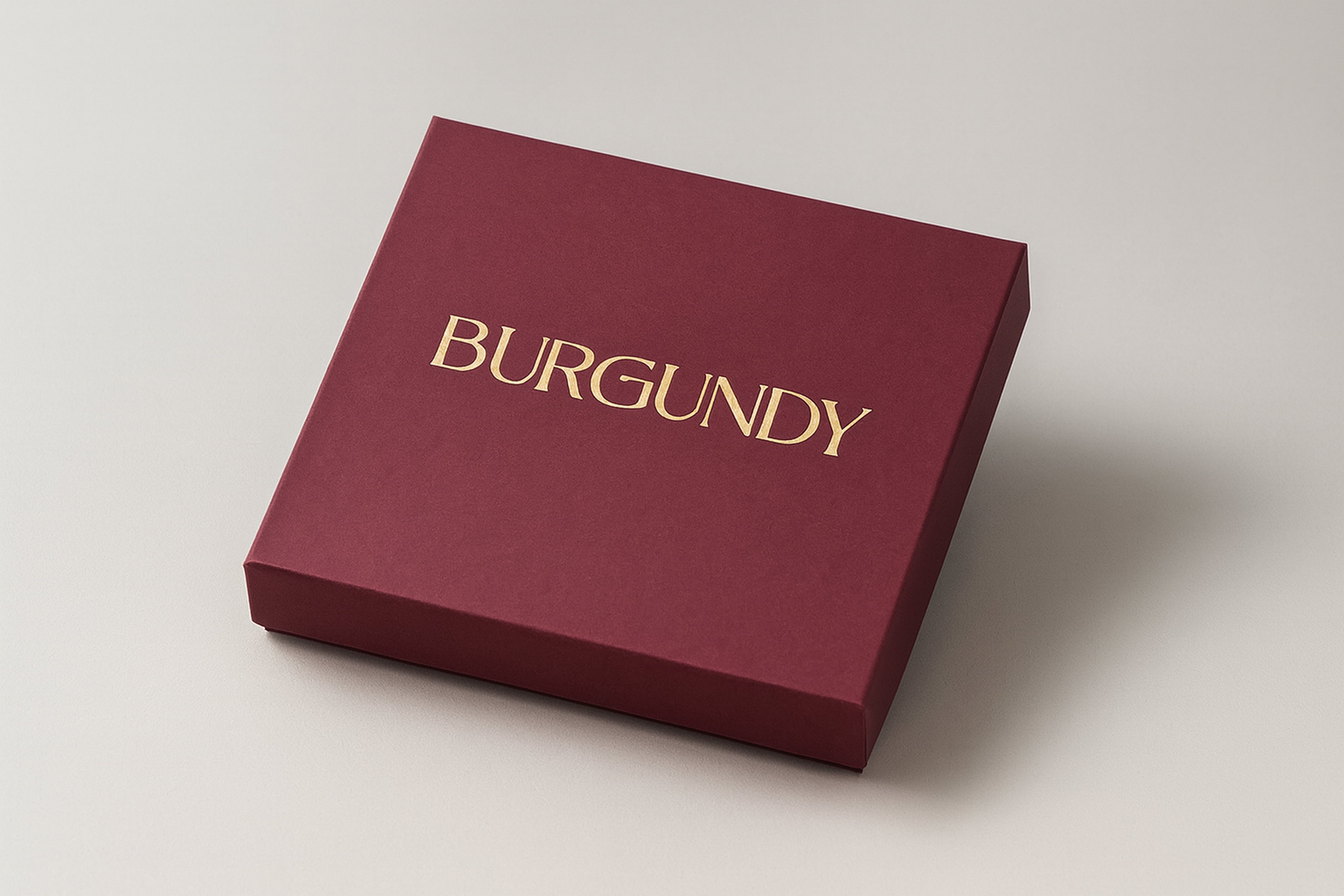 Closed burgundy-colored box with the word 'BURGUNDY' printed in gold on the lid.