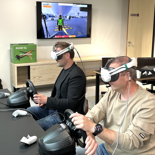 Photo from the training. Two people in a VR headset perform training tasks