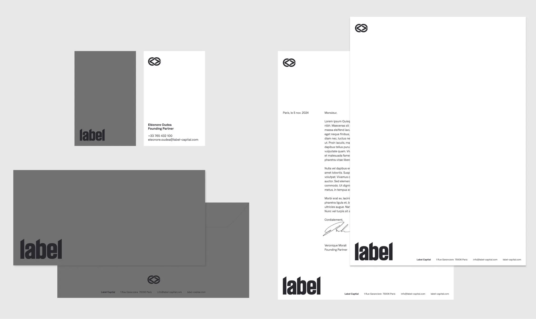 Minimalist stationery set including business cards, envelopes, and letterheads with black bold 'label' text and a circular logo on white and gray backgrounds.