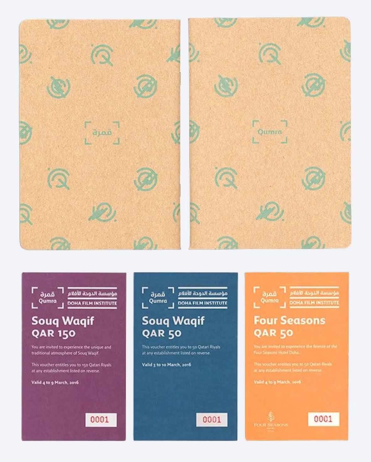 Two brown notebooks with green Qumra logos on top and three vouchers below for Souq Waqif and Four Seasons at Doha Film Institute.